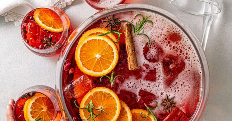 Festive Christmas cocktails with orange, cranberry and rosemary